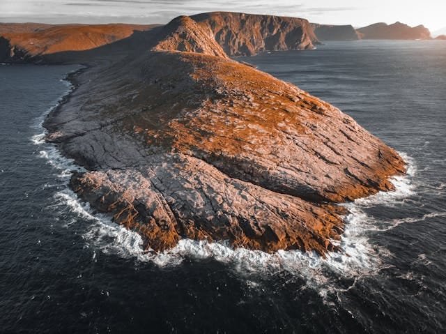 Waves crashing aginst a outlier rock